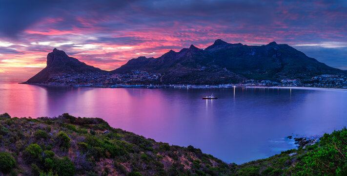 Panorama shot of Hout Bay and fishermans village at dusk with a colorful sky, Cape Town, South Africa