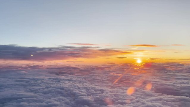 Aerial view from the airplane cabin. Clouds. Sunrise.