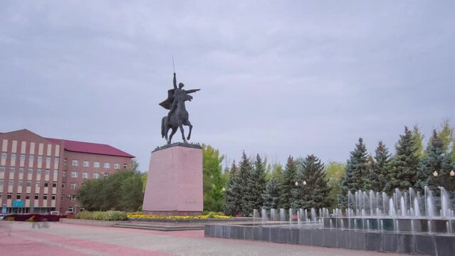 Timelapse Hyperlapse of Monument to Chapaev in Uralsk. A Walk Through the Pedestrian Zone in the City Center Under a Cloudy Sky, Commemorating Historical Valor in Kazakhstan
