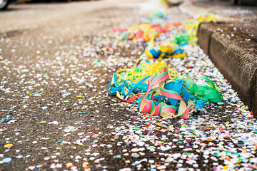 Colorful confetti and streamers at the street after Carnival show