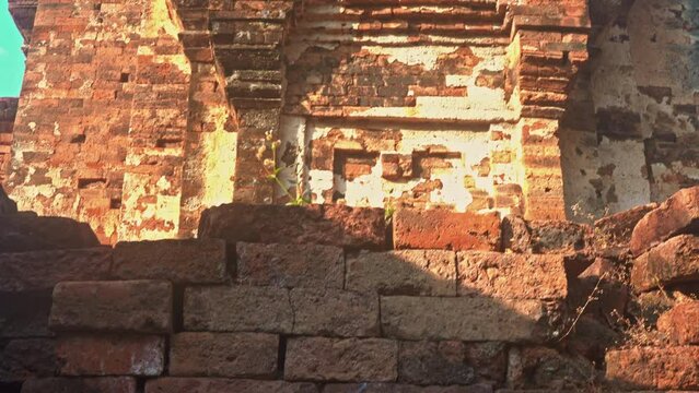 The ruins of an old castle built with laterite bricks of the ancient city of Si Thep..Ancient Angkor Temple Tower Amidst Park's Historic Stone Ruins and Towering Trees .in Si Thep Historical Park.