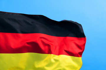 Germany flag waving on blue background