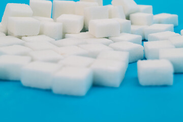 Fototapeta premium Sugar cubes on blue background