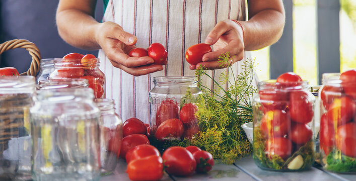 Preserving tomatoes in jars. Selective focus.