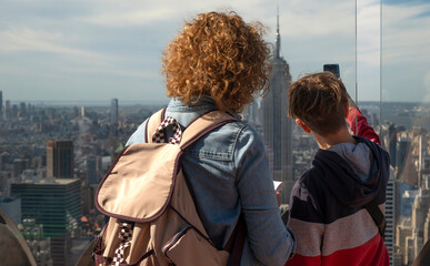 Overlooking the sweeping skyline, a family enjoys a panoramic view of New York City with the Empire State Building at the center. 