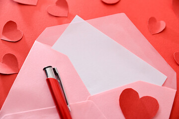 Open envelope with blank letter on red background and pen