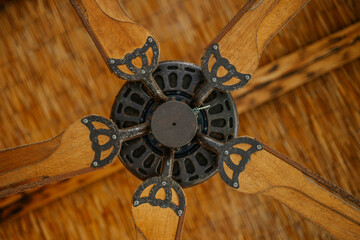 Sotogrante, Spain - January 25, 2024 - Vintage ceiling fan with wooden blades and ornate metal...
