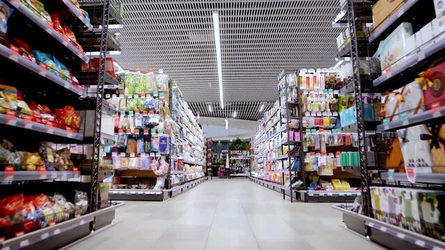 Food counters and shoppers in a supermarket.