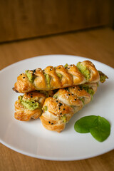 Turkish borek rolls with spinach and cheese on the white plate. A traditional Turkish pastry