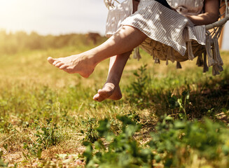 Women legs, feet on summer holiday. Barefoot girl relaxing, resting outdoors in nature on sunny day