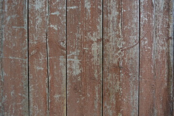 Old, long-painted wood with brown paint. Worn wooden gray planks with peeling paint. Gray old, aged, beautiful, shabby wooden background, made from natural wood, timber.