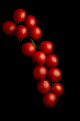 Bunch  of ripe cherry tomatoes. Each tomato is about 20mm in diameter.