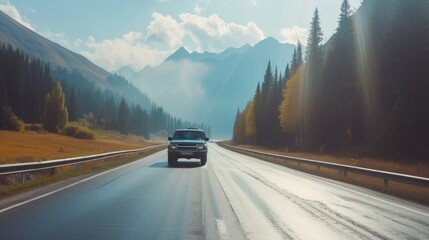 Pickup truck running on the beautiful road along the mountains and forest. Front side view of a pickup truck with a snorkel on a highway road and majestic nature in the background - obrazy, fototapety, plakaty