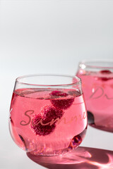 Cold pink drink with raspberry