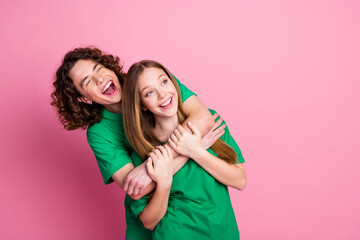 Photo of two best friends sister and brother in green t shirt laughing looking novelty when hugging...