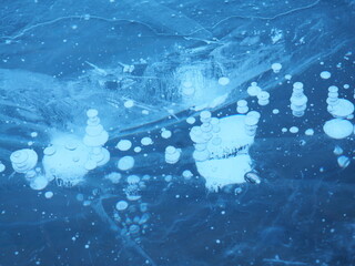 Hokkaido, Japan - January 30, 2024: Ice bubbles on the surface of a frozen lake Akan in Hokkaido, Japan
