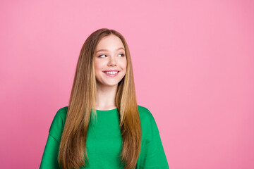 Fototapeta premium Portrait of blonde hair youth girl wearing green t shirt looking empty space dreaming about shopping isolated on pink color background