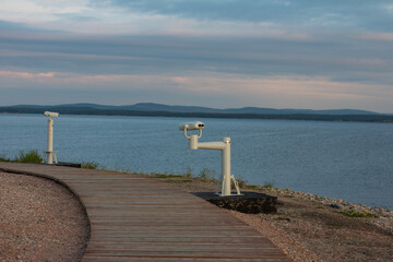 binoculars on the embankment. Landscape on the White sea, recreation area
