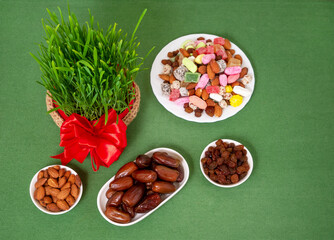 The vernal equinox, a traditional table on Navruz. wheat grass, Arabic baklava dessert, sweets, nuts, dried fruits