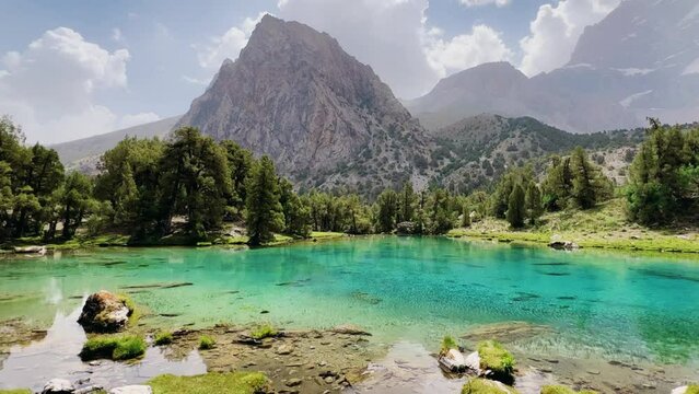 The Alaudin (Chapdara) lakes, lying at an altitude of 2800 m, are considered one of the most beautiful lakes of the Fan Mountains. Turquoise mountain lake. Pamiro-Alai. Tajikistan, Pamir 4K