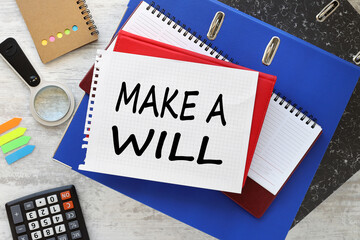 Make a will various office supplies on the table. text on a notepad