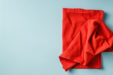 Top view of red empty kitchen napkin isolated on table background Folded cloth for mockup with space for text Simple and minimalist flat lay style