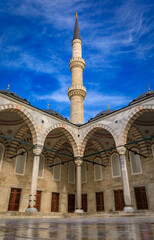 Fototapeta na wymiar Minaret and internal courtyard of the Sultan Ahmed or the Blue Mosque, a majestic Ottoman imperial mosque, major cultural site in Istanbul, Turkey