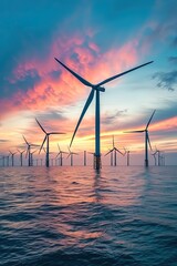 Offshore wind farm at beautiful dramatic sunset. Majestic turbines harnessing the power of the wind at the offshore wind farm.