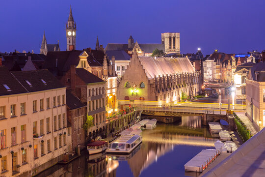 Aerial view of medieval buildings on quay Graslei and Leie river at night, Ghent, Belgium