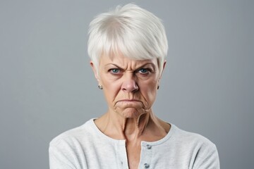 Angry belligerent senior woman looking at the camera - obrazy, fototapety, plakaty