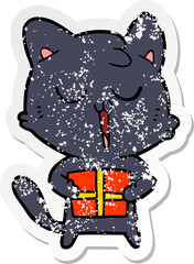 distressed sticker of a cartoon cat with present