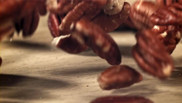 Pecans fall on the table. Filmed on a high-speed camera at 1000 fps. High quality FullHD footage