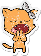 distressed sticker of a cartoon yawning cat