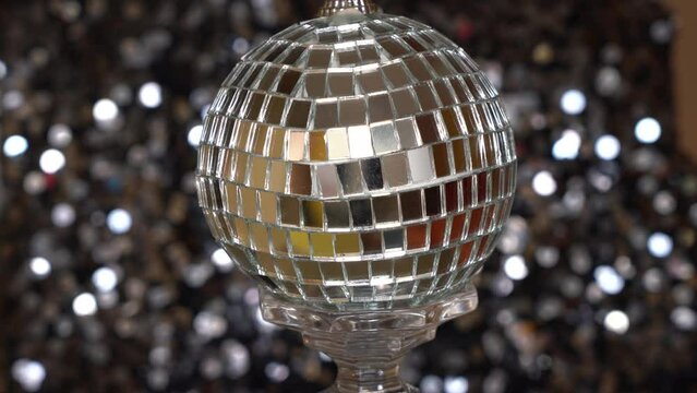 silver ball with mirrors rotates