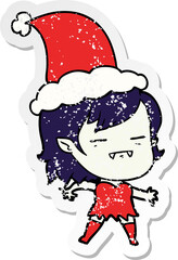 distressed sticker cartoon of a undead vampire girl wearing santa hat