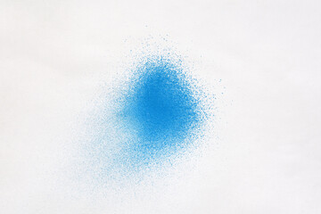 a blue spray paint stain on a white paper background