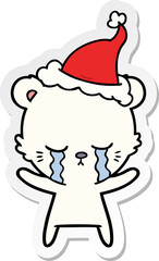 crying sticker cartoon of a polarbear wearing santa hat