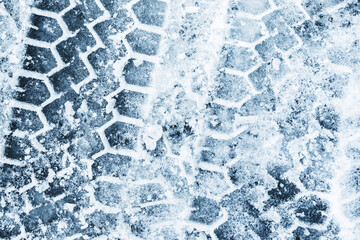 Snow tyre mark. Asphalt covered in snow. Dangerous road conditions. Car imprint on frozen ground....