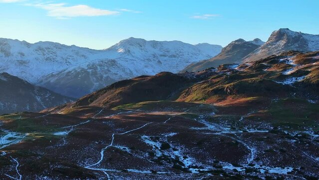 Aerial of the snowy Langdale Pikes, Cumbrian mountains, Lake District National Park, Cumbria, England