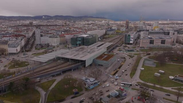 Aerial slide and pan footage of Praterstern railway station. Modern elevated transport infrastructure above large roundabout in urban borough. Vienna, Austria