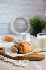 Traditional finnish cinnamon and cardamon rolls, korvapuusti. Home made buns with milk for breakfast. Hight key. 