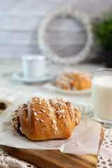 Traditional finnish cinnamon and cardamon rolls, korvapuusti. Home made buns with milk for breakfast. Hight key. 