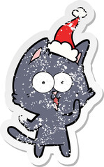 funny distressed sticker cartoon of a cat wearing santa hat