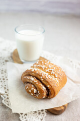 Traditional finnish cinnamon and cardamon rolls, korvapuusti. Home made buns with milk for breakfast. Hight key. 