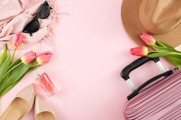 Springtime wanderlust: embracing blossoming adventures. Top view photo of suitcase, heels, hat, scarf, sunglasses, parfum, tulips on pastel pink background with promo area