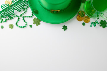 Chic green spectacle: St. Patrick's soirée. Top view photo of leprechaun hat, green beer, party eyewear, trefoils, coins, beads on white background with greeting area - Powered by Adobe