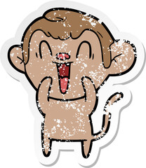 distressed sticker of a cartoon laughing monkey