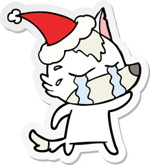 sticker cartoon of a crying wolf wearing santa hat