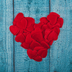 Heart shape made from small hearts on a wooden background. Valentine's Day.