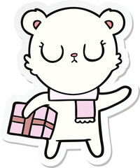 sticker of a peaceful cartoon polar bear with christmas gift